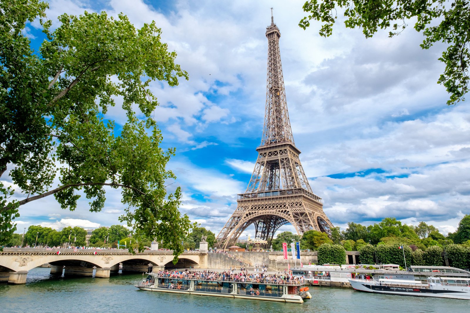 The Eiffel Tower and cruise boats on the Seine on a summer day 